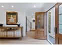 Bright entryway with hardwood floors, stylish console table, and glass paneled doors at 2231 Fairoaks Rd, Decatur, GA 30033