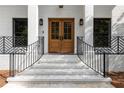 Elegant front entrance with double doors, black railings, and white brick steps at 2231 Fairoaks Rd, Decatur, GA 30033