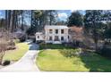 Expansive front lawn view of beautiful home exterior with mature trees and curved driveway at 2231 Fairoaks Rd, Decatur, GA 30033