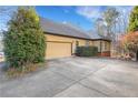 Spacious driveway leading to a two-car garage, surrounded by mature trees at 772 Crescent Cir, Canton, GA 30115