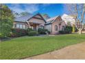 Attractive home featuring a well-maintained lawn and lush shrubbery enhancing its curb appeal at 772 Crescent Cir, Canton, GA 30115