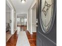 Entryway with hardwood floors and a decorative glass insert in the front door at 4072 Whispering Forest Ct, Lilburn, GA 30047