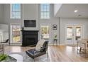 Bright living room with high ceilings, a fireplace, large windows, and access to the outdoor space at 4525 Chelton Se Ct, Smyrna, GA 30080