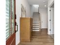 Bright entryway with hardwood floors, leading to a staircase and other rooms in the house at 6785 Pippin Walk, Alpharetta, GA 30005