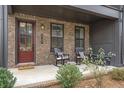Charming front porch with rocking chairs, offering a welcoming entrance to the home at 6785 Pippin Walk, Alpharetta, GA 30005