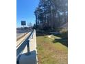 Roadside view with a guardrail and green space at 1902 Godby Rd, Atlanta, GA 30349