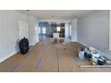 Spacious living room featuring light blue walls and view into kitchen with marble counters at 1064 Eastview Ne Rd, Conyers, GA 30012