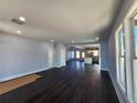 Bright and airy living room showcasing hardwood floors and an open floorplan into the modern kitchen at 1064 Eastview Ne Rd, Conyers, GA 30012