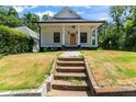 Charming home with a white exterior, black trim, and a inviting front porch at 203 Sunset Nw Ave, Atlanta, GA 30314