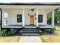 Inviting front porch with columns and black accents, perfect for relaxing outdoors at 203 Sunset Nw Ave, Atlanta, GA 30314