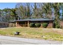 Cozy brick home with a covered porch and a front lawn, showing the home's curb appeal at 228 W Simon Nw Ter, Atlanta, GA 30318