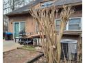 Back patio with various items, including a grill and table at 43 Willowick Ct, Stonecrest, GA 30038