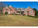Beautiful brick home with a manicured lawn, showcasing classic architectural details at 589 Cook Dr, Ellenwood, GA 30294