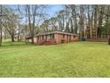 Beautifully maintained lawn surrounds this cozy brick home with mature trees at 1678 Capistrana Pl, Decatur, GA 30032