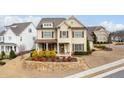 Beautifully landscaped two-story home featuring a welcoming front porch and stone retaining wall at 2601 Boulder Way, Woodstock, GA 30188