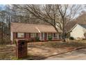 Beautiful brick home featuring a red and white porch in a quiet neighborhood with mature trees at 541 Exam Ct, Lawrenceville, GA 30044