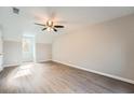 Bright bedroom with vaulted ceiling, ceiling fan, gray walls, and durable laminate flooring at 1765 Round Rd, Grayson, GA 30017
