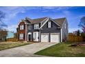 Beautiful home with a two-car garage, brick details, nice landscaping, and a freshly mowed lawn at 3028 Hallman Cir, Marietta, GA 30064