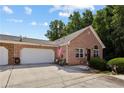 Charming single-story brick home with a spacious two-car garage and a well-manicured front lawn, creating an inviting curb appeal at 3321 Raes Creek Rd # 11, Marietta, GA 30008