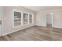 Bright living room showcasing large windows and luxury vinyl plank flooring at 2212 Brannen Se Rd, Atlanta, GA 30316