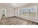 Bright living room featuring fresh paint, large windows, and luxury vinyl plank flooring at 2212 Brannen Se Rd, Atlanta, GA 30316