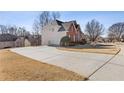 Side view of home featuring long driveway and attached two car garage at 1331 Dayspring Trce, Lawrenceville, GA 30045