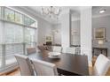 Elegant dining room features a chandelier, large window, and neutral color palette at 1552 Mosaic Way, Smyrna, GA 30080