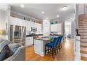 Stylish kitchen with stainless steel appliances, an island with bar seating, and hardwood floors at 1552 Mosaic Way, Smyrna, GA 30080