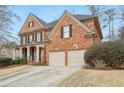 A well-maintained two-story brick home features an attached two-car garage and an inviting facade at 1085 Highland Crest Ct, Mableton, GA 30126