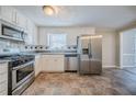 Bright kitchen features stainless steel appliances, stone countertops and tile backsplash at 2858 Carrousel Ct, Stone Mountain, GA 30087