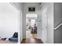 Inviting hallway with hardwood floors leading to a dining area and tiled kitchen at 6153 Idlewood Pass, Lithonia, GA 30038