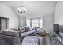 Comfortable living room featuring a large sofa, bay windows, and neutral decor at 6153 Idlewood Pass, Lithonia, GA 30038