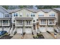 A row of inviting townhomes with garages and balconies, showcasing a tidy facade and modern architectural details at 1152 Liberty Nw Pkwy, Atlanta, GA 30318