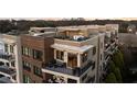 Close up of a multi-story apartment building with rooftop deck featuring outdoor furniture at 675 Drewry Ne St # 602, Atlanta, GA 30306