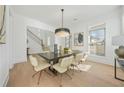 Elegant dining room with hardwood floors, modern chandelier, and large windows at 2018 Stonecreek Dr, Woodstock, GA 30188