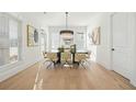 Elegant dining room with hardwood floors, modern chandelier, and large windows at 2018 Stonecreek Dr, Woodstock, GA 30188
