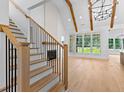 Open concept living area with hardwood floors, large windows, and a fireplace at 210 Regester Way, Peachtree City, GA 30269