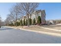 Scenic street showcasing well-kept townhomes with lush greenery and curb appeal at 3966 Covey Flush Sw Ct # 20, Smyrna, GA 30082