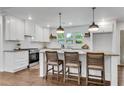 Modern kitchen features white cabinetry, granite countertops, stainless steel appliances, and eat-in island at 4770 Wayland Cir, Acworth, GA 30101