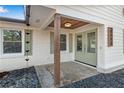 Inviting front porch with stylish wood accents, chic rain chains, and fresh neutral paint at 4770 Wayland Cir, Acworth, GA 30101