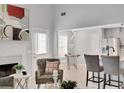 Bright living room with modern decor, fireplace, and views into breakfast area and kitchen at 10 Oakbrook Ln, Covington, GA 30016