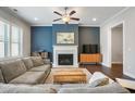 Inviting living room featuring hardwood floors, a fireplace and a large comfortable couch at 11 Ganel Ln, Alpharetta, GA 30009