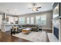 Open-concept living space featuring hardwood floors, a modern kitchen and a comfortable sofa at 11 Ganel Ln, Alpharetta, GA 30009