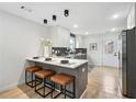 Modern kitchen with stainless steel appliances, breakfast bar, and sleek countertops at 176 Rhodesia Se Ave, Atlanta, GA 30315