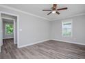 Light-filled bedroom showcases modern wood floors, neutral paint, and large windows at 1857 Dunlap Ave, East Point, GA 30344