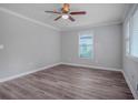 Bright bedroom featuring wood-look flooring, neutral walls, and a ceiling fan at 1857 Dunlap Ave, East Point, GA 30344