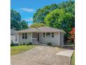 Inviting single-story home with neat landscaping and a concrete driveway at 1857 Dunlap Ave, East Point, GA 30344