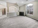 Spacious living area with fireplace, large window, and neutral carpeting at 1394 Orchard Park Dr, Stone Mountain, GA 30083