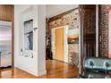 Welcoming hallway with hardwood floors, exposed brick, and unique architectural details at 500 Means Nw St # F, Atlanta, GA 30318