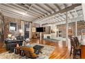 Spacious living room featuring exposed brick, beamed ceilings, and abundant natural light at 500 Means Nw St # F, Atlanta, GA 30318